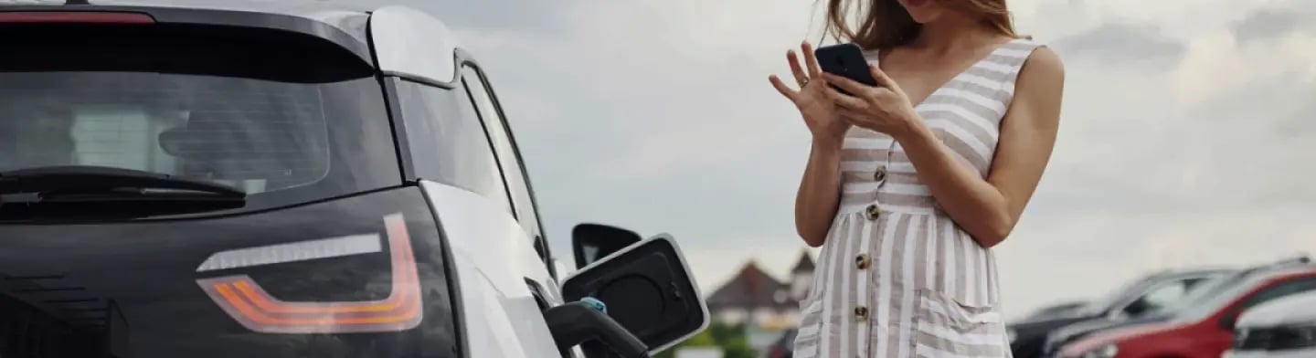 Woman photographing an EV